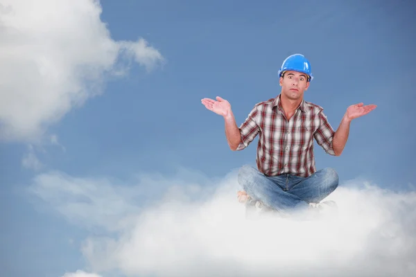 Montage av en elektriker som sitter på ett moln — Stockfoto