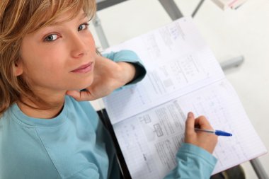 Prepubescent boy sitting an exam clipart