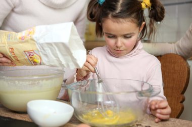 Young girl learning how to cook clipart