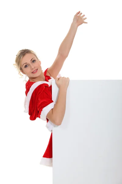 Vrouw in een kerstman pak houden een poster — Stockfoto