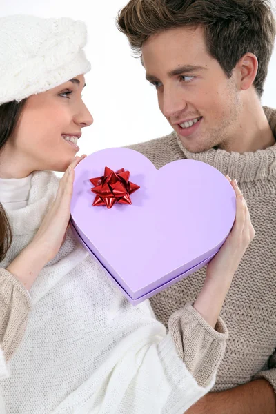 Casal segurando caixa em forma de coração — Fotografia de Stock