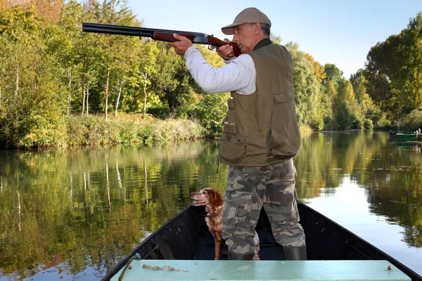 Hunter in boat — Stock Photo, Image