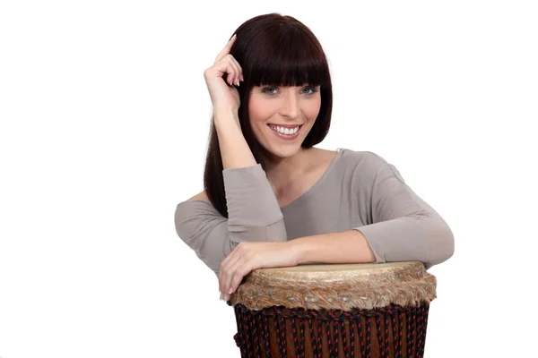 Woman leaning on drum — Stock Photo, Image