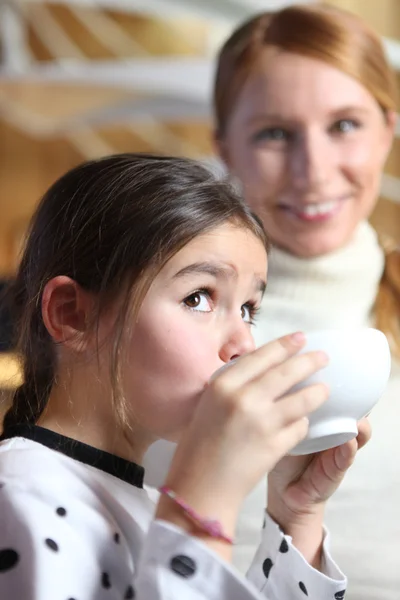 Little girl drinking from breakfast bowl — Stock Photo, Image