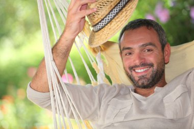 Man with hat on hammock clipart