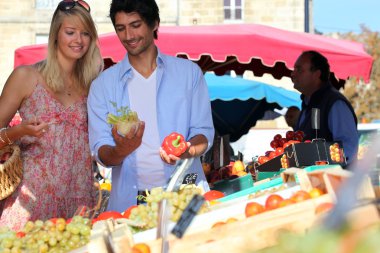 Young couple at a market stall clipart