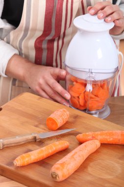 Woman chopping carrots clipart