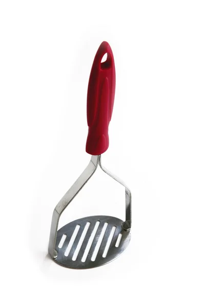 Серебряный картофельный машер с красной ручкой — стоковое фото