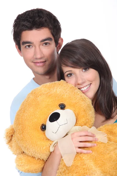 Teenagers with a large teddy bear — Stock Photo, Image
