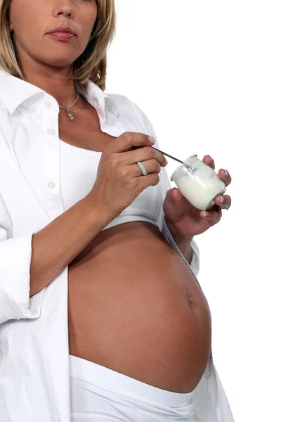 Kobieta w ciąży jedzenie jogurt — Zdjęcie stockowe