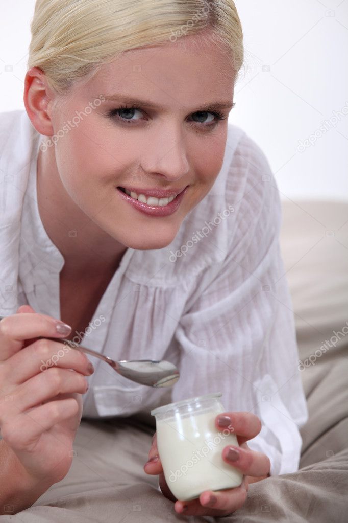 Woman eating yogurt in bed Stock Photo by ©photography33 10402113