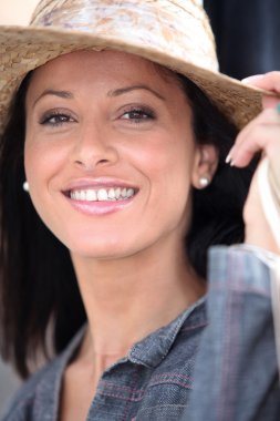 Attractive brunette wearing straw hat clipart