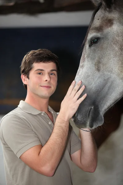 Молодий чоловік з конем — стокове фото