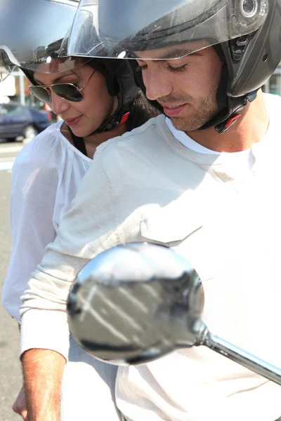 Pareja montando un scooter juntos — Foto de Stock