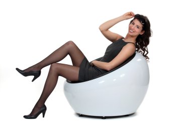 Sexy woman relaxing on chair clipart