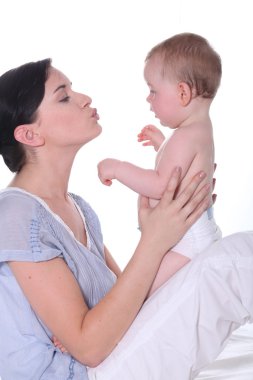 Woman kissing her baby clipart