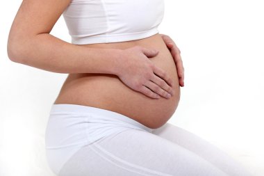 Pregnant woman touching her belly clipart