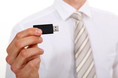 Businessman holding USB stick clipart