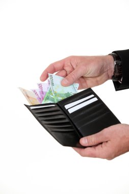 A hand taking bills out of a wallet. clipart