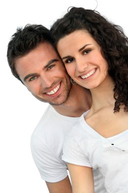 Cheerful couple in front of blue wall clipart