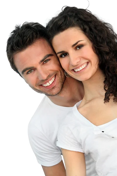 Cheerful couple in front of blue wall — Stock Photo, Image