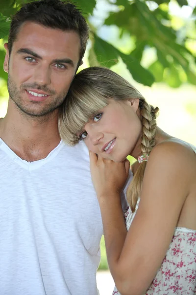 Blond woman leaning on man's shoulder — Stock Photo, Image