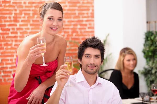 Smart couple drinking champagne at a party — Stock Photo, Image