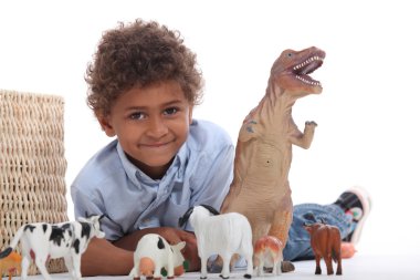 Young boy with his toy animals clipart