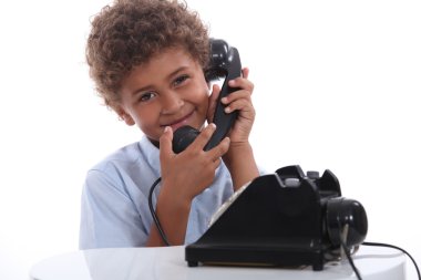 Little boy calling with an old telephone clipart