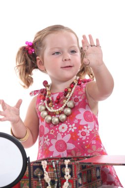 Girl putting on jewellery clipart