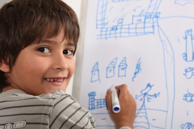 Boy drawing on blackboard clipart