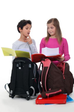 Schoolchildren comparing homework clipart