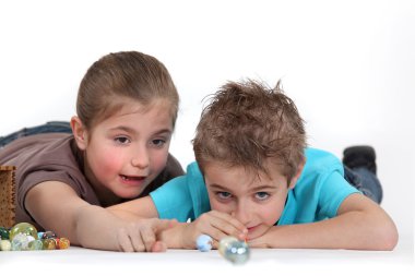 Child playing with marbles clipart