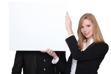 Businessman and businesswoman holding an advertising board clipart
