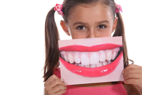 Little girl holding photo of mouth — Stock Photo, Image