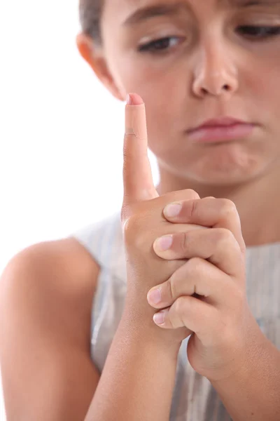 Little girl with hurt finger — Stock Photo, Image