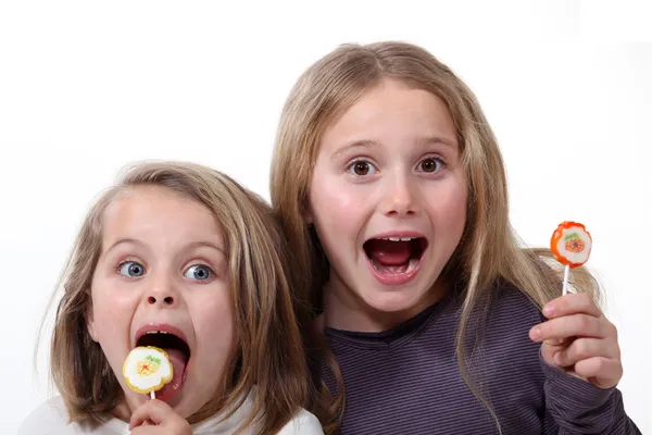 Little girls with lollipops — Stock Photo, Image