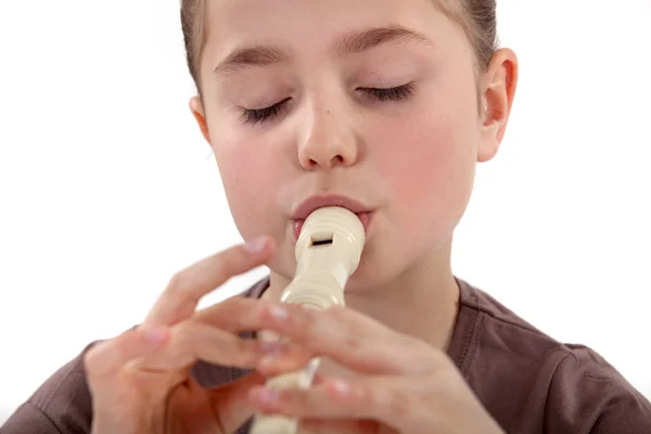 Little girl playing the recorder — Stock Photo, Image