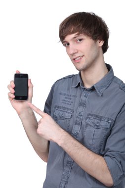 Young man showing a blank touch screen cellphone clipart