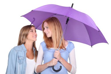 Two girls under an umbrella clipart