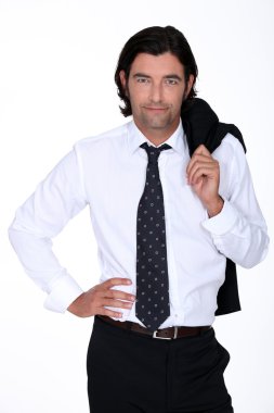Good looking man in a suit holding his jacket over his shoulder clipart