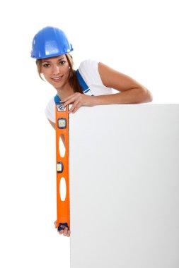 Woman checking a blank board is straight with a spirit level clipart