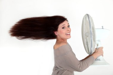 Woman with an electric fan clipart