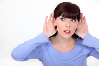 Woman with her hands to her ears listening clipart