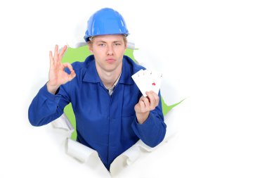 Tradesman giving the a-ok sign and holding up cards clipart