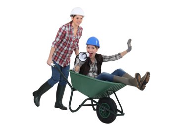 Woman being pushed around in wheelbarrow clipart