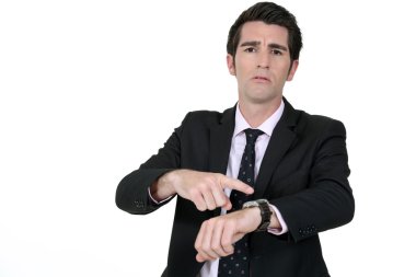 Businessman pointing at his watch clipart