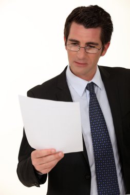 Businessman reading a document clipart