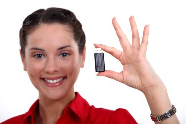 Brunette holding USB stick clipart