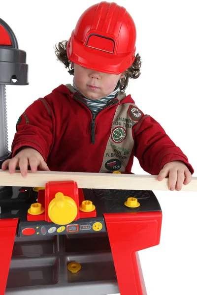 Menino brincando com conjunto de brinquedos de carpinteiro — Fotografia de Stock